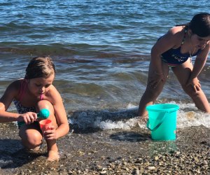 Photo of kids in the surf at a beach - End of Summer Bucket List