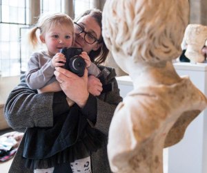 Photo of parent and child with camera at Yale Art Gallery