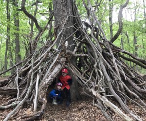 kids hiding in stick structure along a hiking path