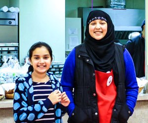 Photo of adult and kid volunteering at food pantry in Connecticut.