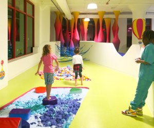 Image of children playing with slime at Sloomoo Institute.