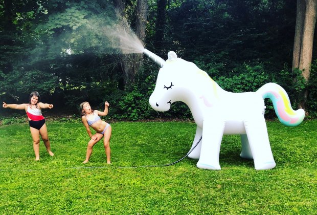 A unicorn sprinkler makes a real splash at a kid party.