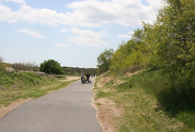 family on a path at Brookhaven Town's Ecology Site;