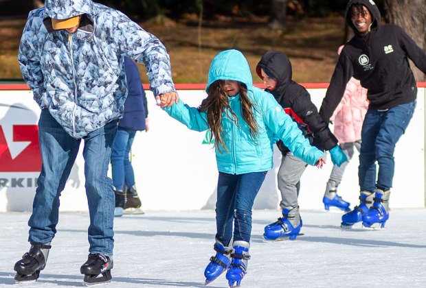 How are outdoor ice skating rinks kept frozen in warmer climates?